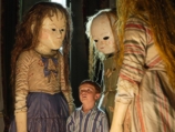George Surrounded by Dolls